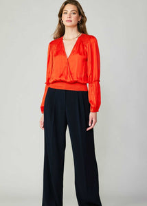 Flame long sleeve neck blouse with pleated detail on sleeve and smocked detail on hem and shoulder.