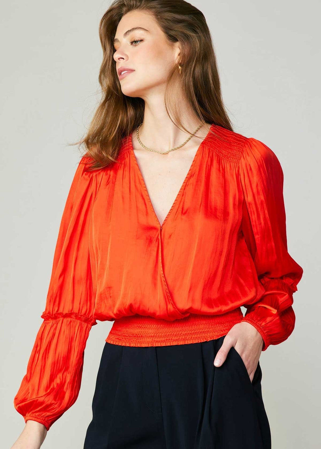 Flame long sleeve neck blouse with pleated detail on sleeve and smocked detail on hem and shoulder.