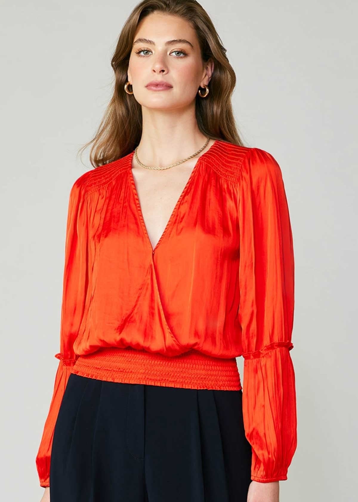 Flame long sleeve neck blouse with pleated detail on sleeve and smocked detail on hem and shoulder.