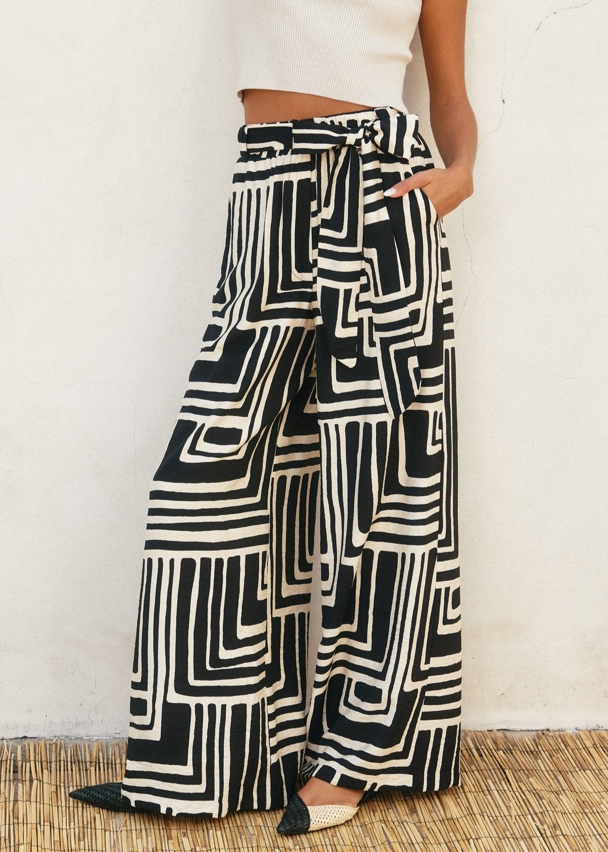 Printed viscose blend wide leg pants. Elastic waist with belt loop. Optional sash belt.