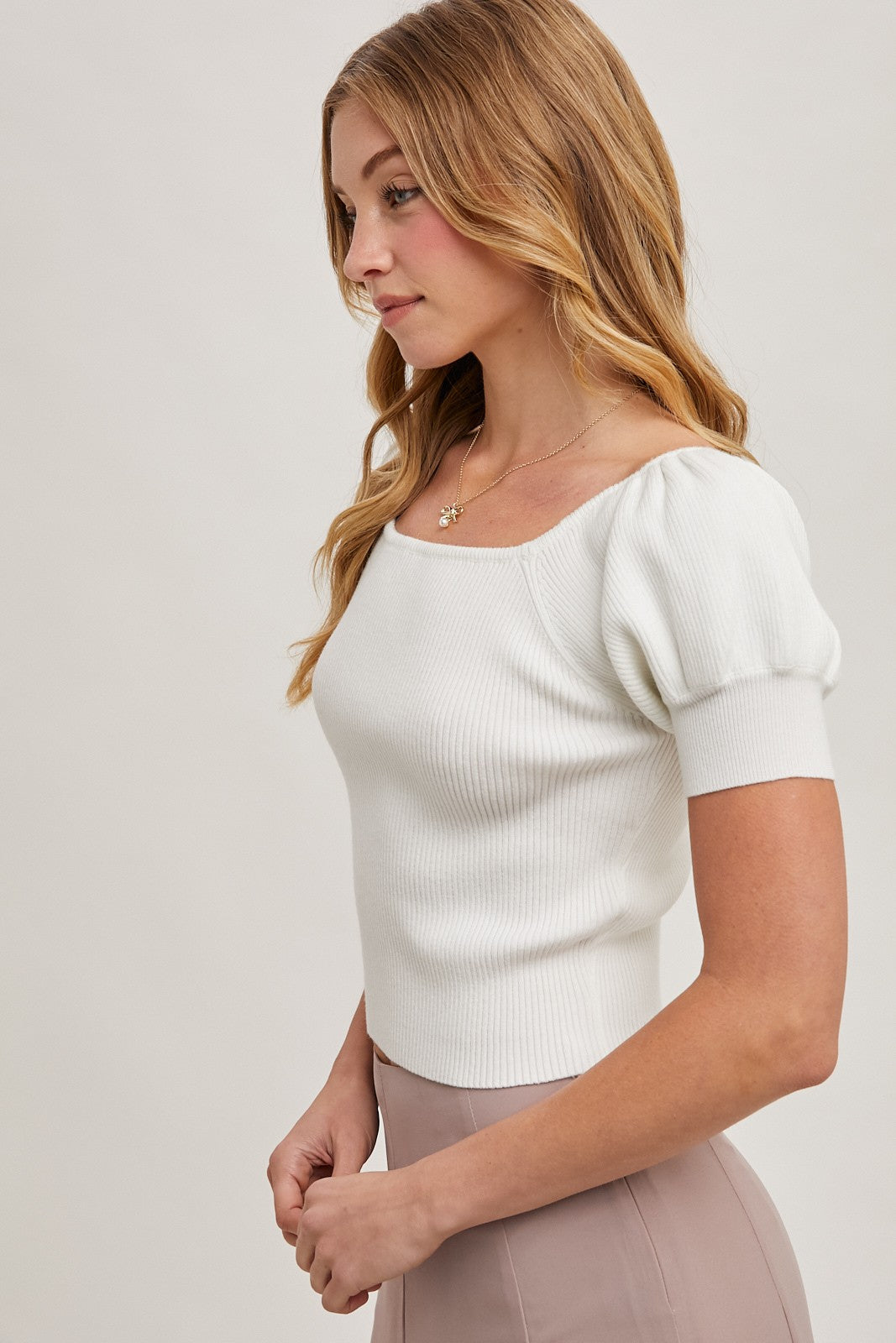 The Square Neck Puff Sleeved Knit Top is a stylish and sophisticated piece that effortlessly blends comfort with elegance. Featuring a flattering square neckline, this top highlights the collarbone while adding a modern touch to your outfit. The puffed sleeves bring a hint of volume and drama, creating a chic silhouette that is both trendy and timeless. Made from a soft and stretchy knit fabric, it ensures a comfortable fit while maintaining its structured look. Perfect for pairing with high-waisted jeans, 