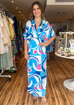 Load image into Gallery viewer, Blue/pink print satin abstract print overlap midi dress with side slits &amp; high low.
