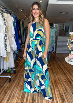 Load image into Gallery viewer, Navy print halter jumpsuit with adjusted waist, pockets and lining.

