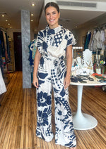 Load image into Gallery viewer, Navy/ ivory abstract floral print satin cowl neck jumpsuit.
