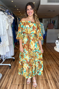 Brown mint printed woven midi dress featuring off shoulder neckline with ruffled edge, 3/4 sleeve, smocked waistband with front lace up toe detail and tiered skirt.