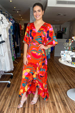 Load image into Gallery viewer, Orange printed wrap around maxi dress with short loose fitting sleeves. Gorgeous ruffle details and adjustable waist. Looks great with a belt.
