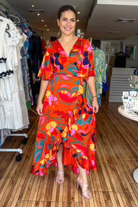 Orange printed wrap around maxi dress with short loose fitting sleeves. Gorgeous ruffle details and adjustable waist. Looks great with a belt.