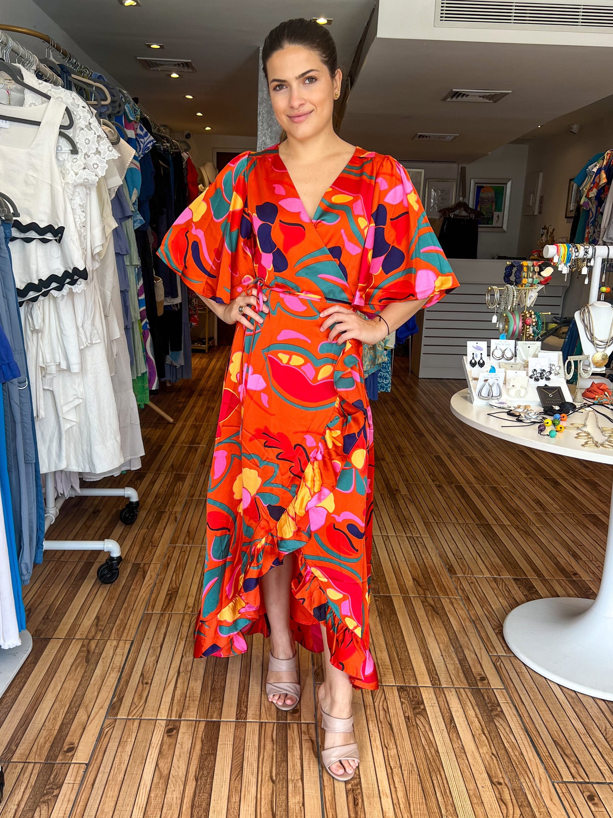 Orange printed wrap around maxi dress with short loose fitting sleeves. Gorgeous ruffle details and adjustable waist. Looks great with a belt.