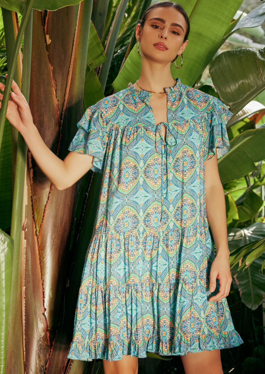 Bohemian printed flutter short sleeve split neck round yoke tiered mini dress with self neck tie and ruffle.
