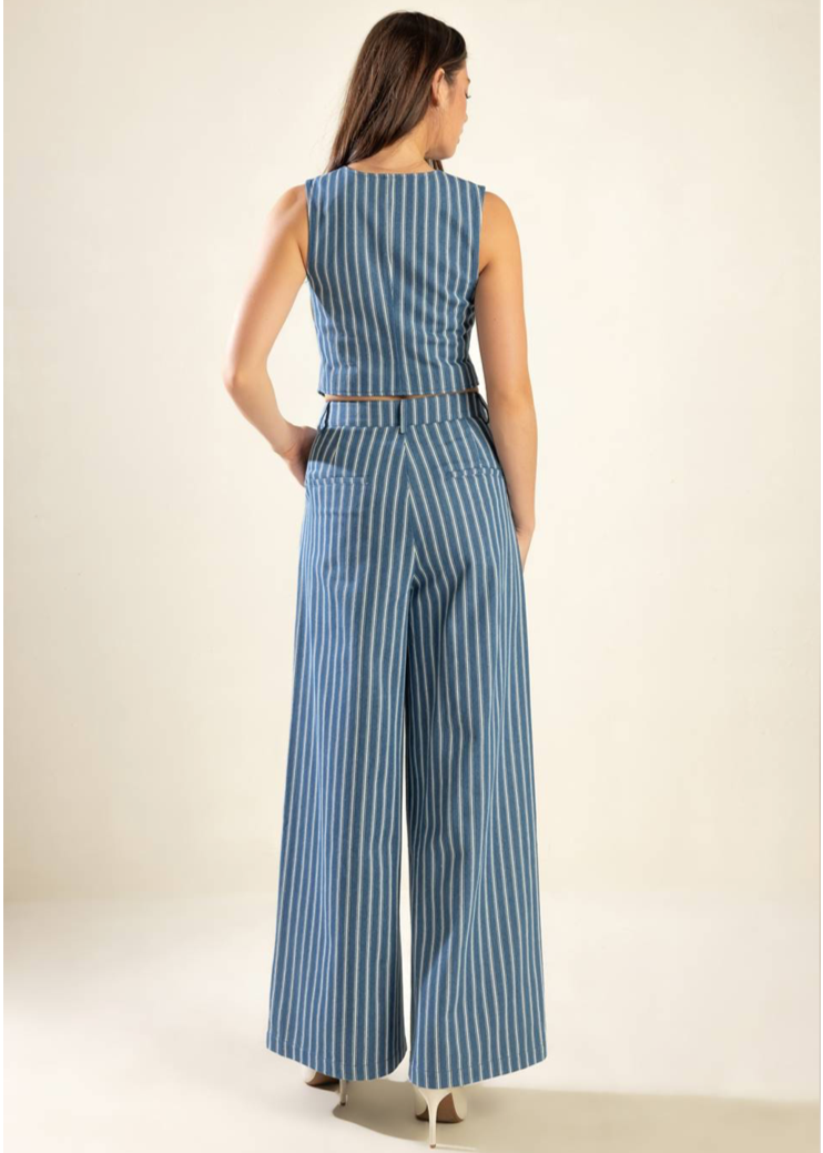 A striped indigo woven vest featuring sleeveless and front button closure. Matching striped woven pant featuring front closure and wide leg.